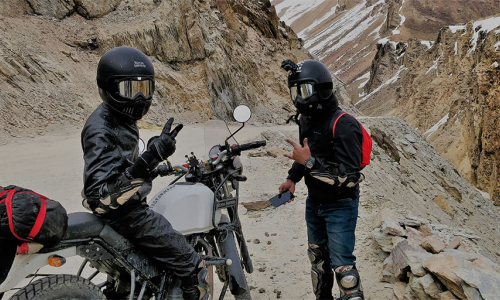 Two bikers in a rocky terrain awaiting GoPro Smart Motorcycle Helmet