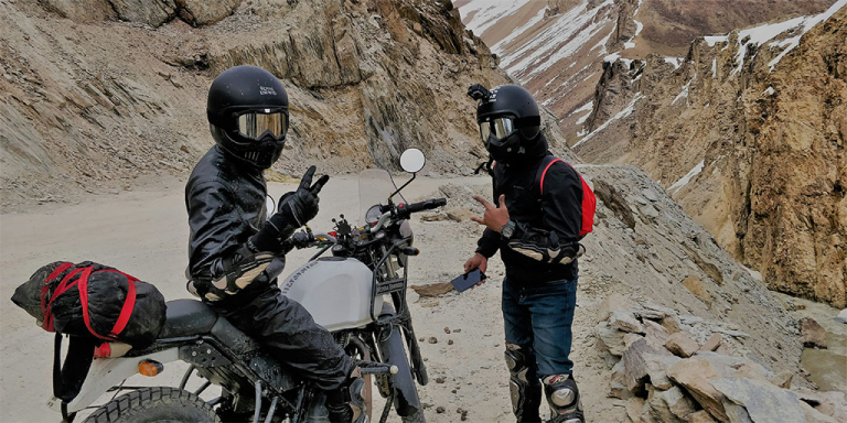 Two bikers in a rocky terrain awaiting GoPro Smart Motorcycle Helmet